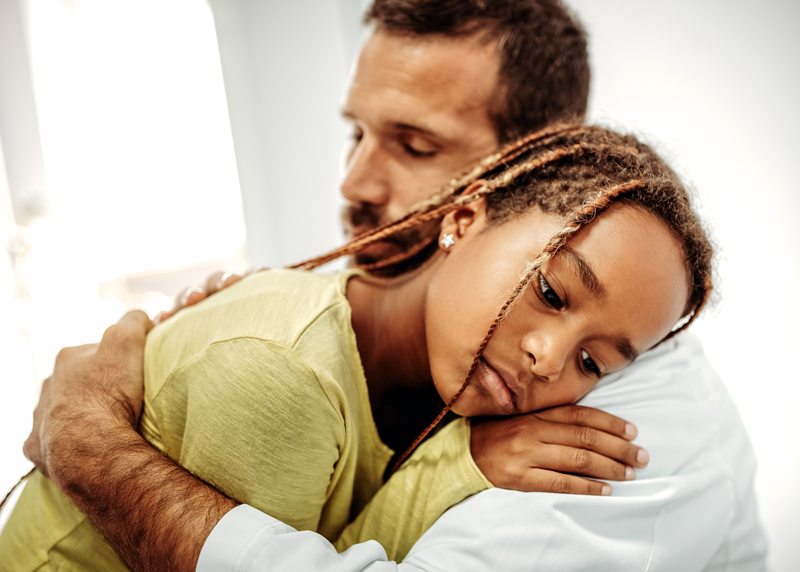 Father comforting his daughter.